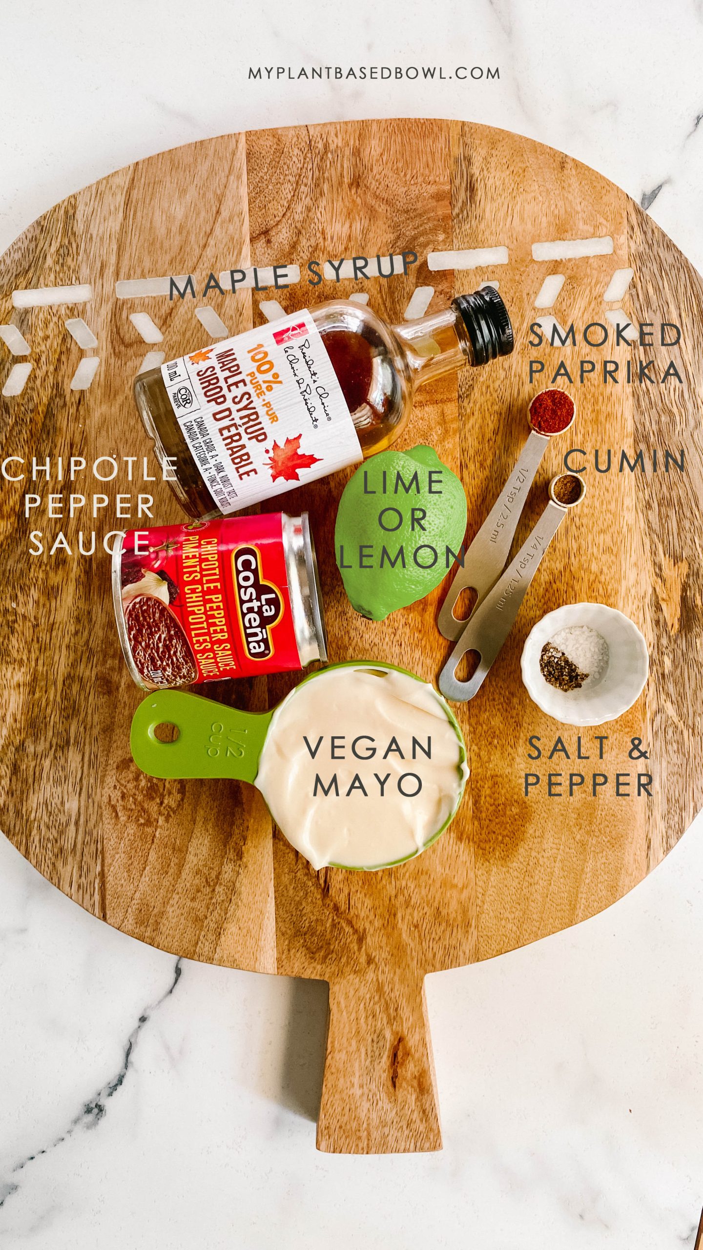 Ingredients for chipotle lime sauce on a wooden platter.