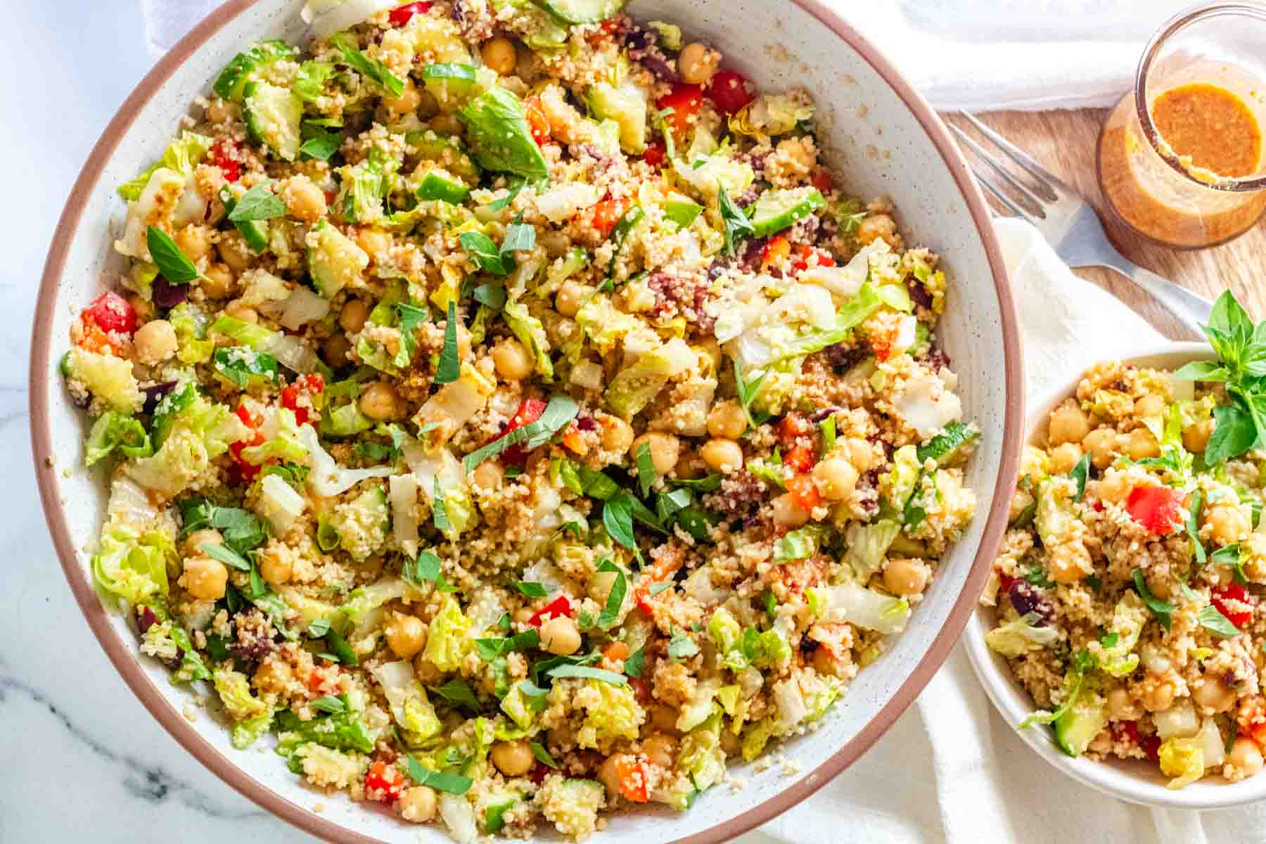 Couscous salad with vegetables and chickpeas in a large serving bowl.