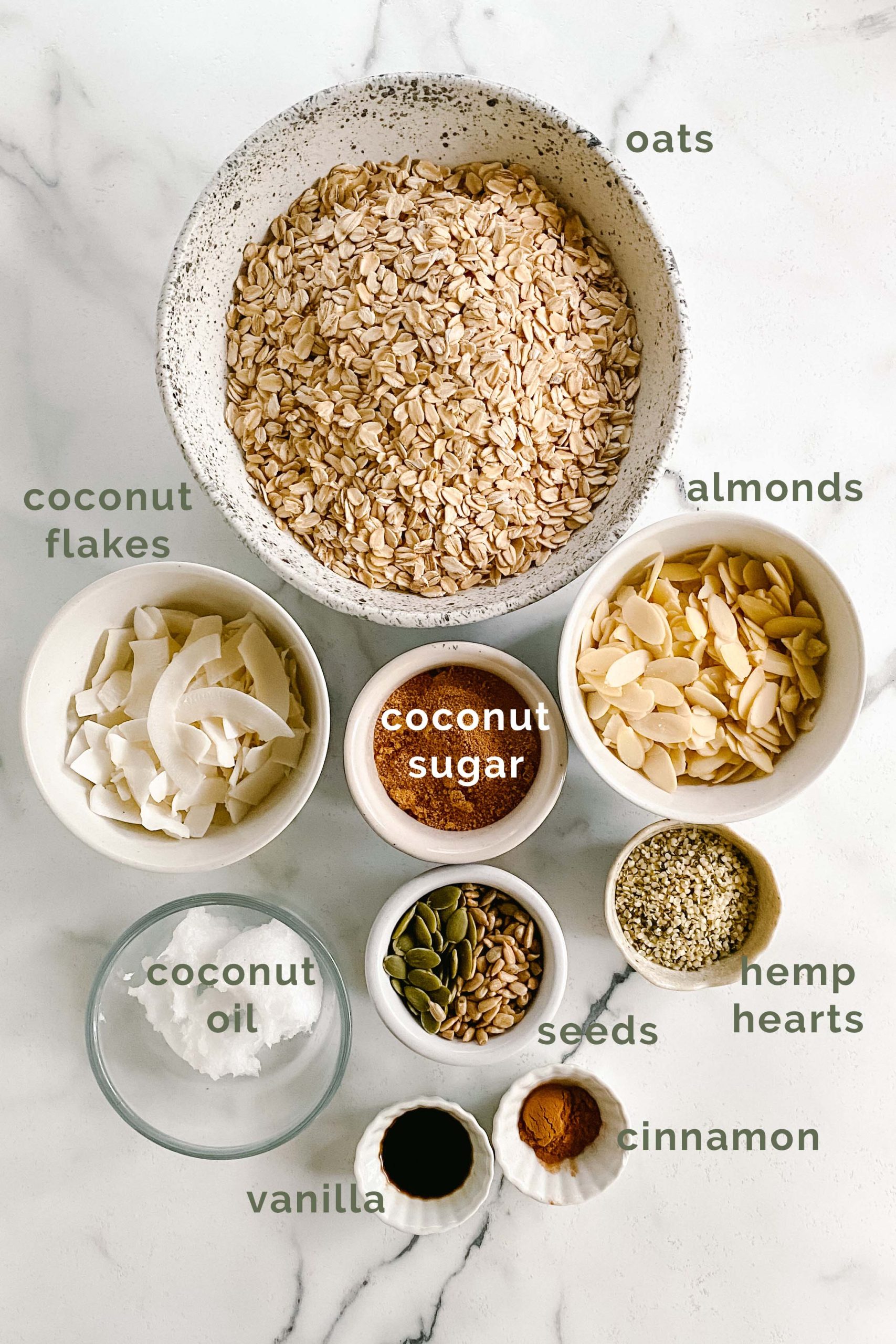 Ingredients for granola on a white marble counter.