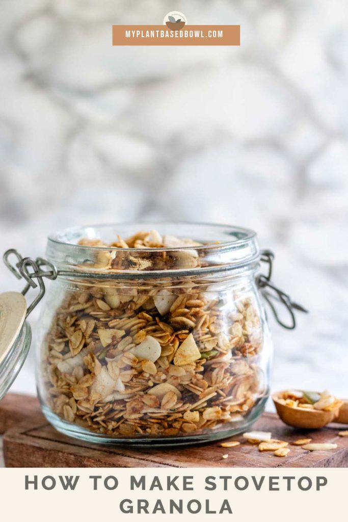 Granola in a glass jar with a text title for Pinterest.