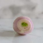 A peeled shallot with a side view of its rings with text title for Pinterest.
