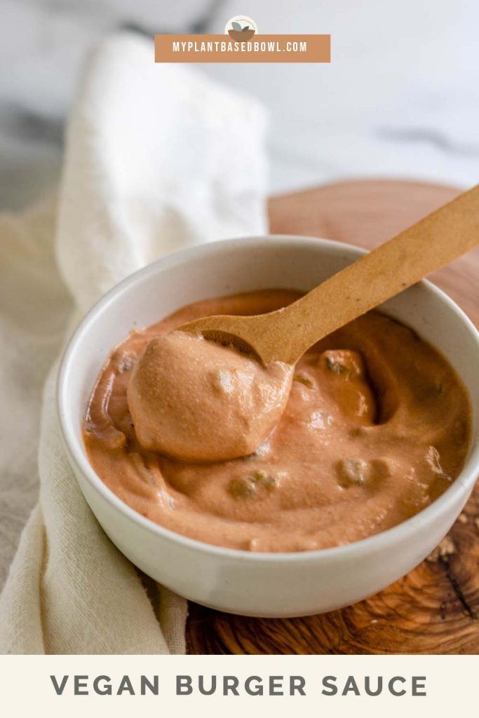 A peachy sauce in a bowl with a wooden spoon in it with text for Pinterest.