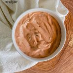 A peachy sauce in a bowl with text for Pinterest.