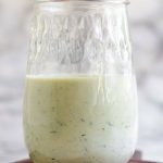 Tzatziki salad dressing in a jar with a text title for Pinterest.