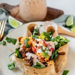 Taco salad in a tortilla bowl with the text taco salad bowls.