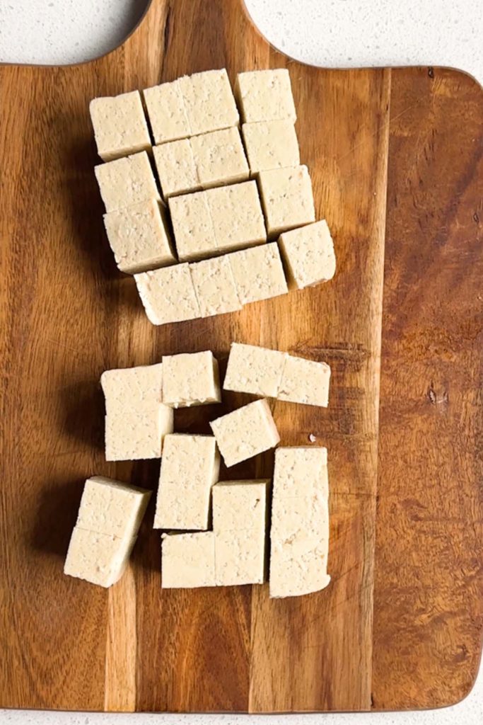 Cubed soy-free tofu ona cutting board.