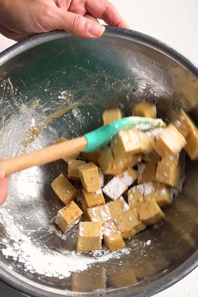 Cubed soy-free tofu tossed in cornstarch and soy sauce before baking.
