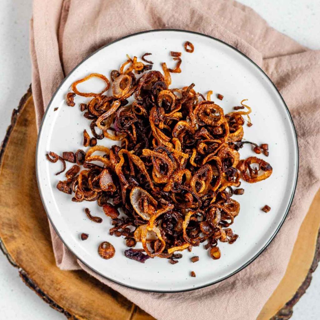 Crispy shallots on a plate.
