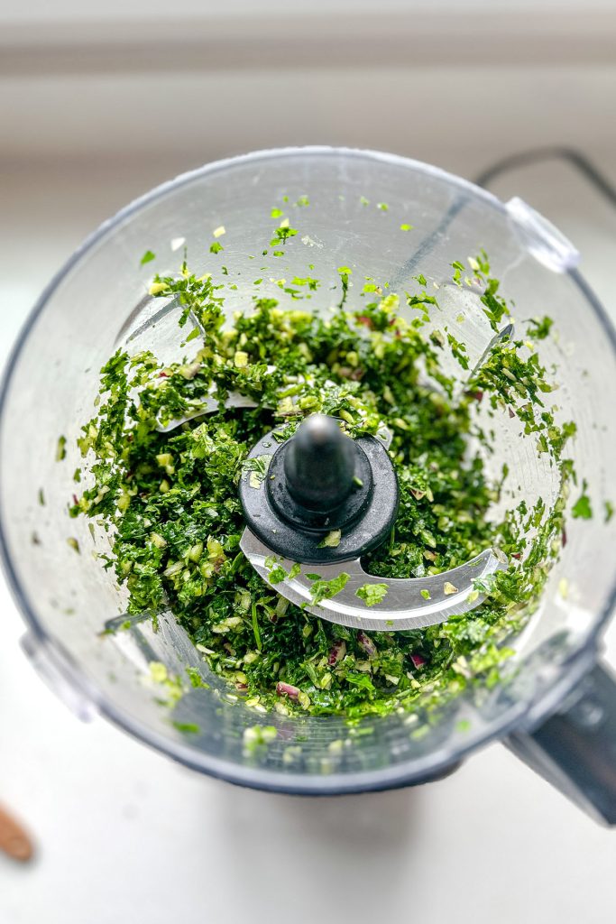 Green sauce in a food processor jar.