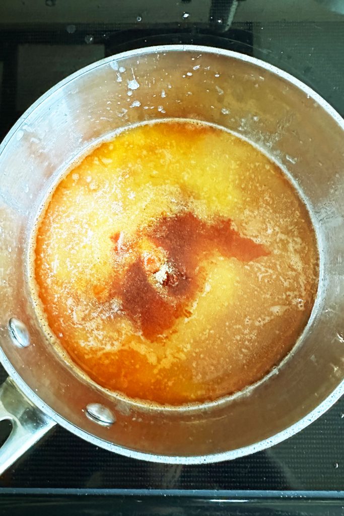 Melted butter with spices in a saucepan.