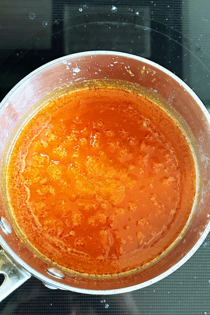 Melted, spiced butter in a saucepan.